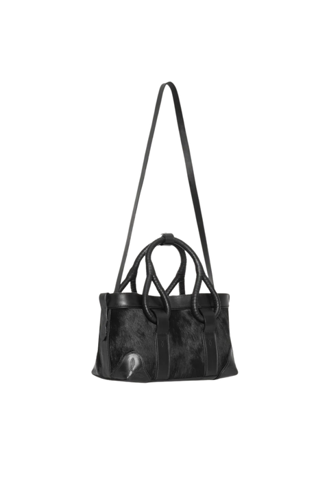 A black leather tote bag with a long shoulder strap and two top handles, shown against a plain white background.