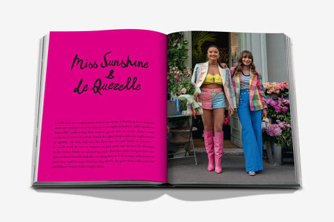 Open book with 'Miss Sunshine & Le Quezelle' on a pink page, showing two women in colorful outfits in a photo.