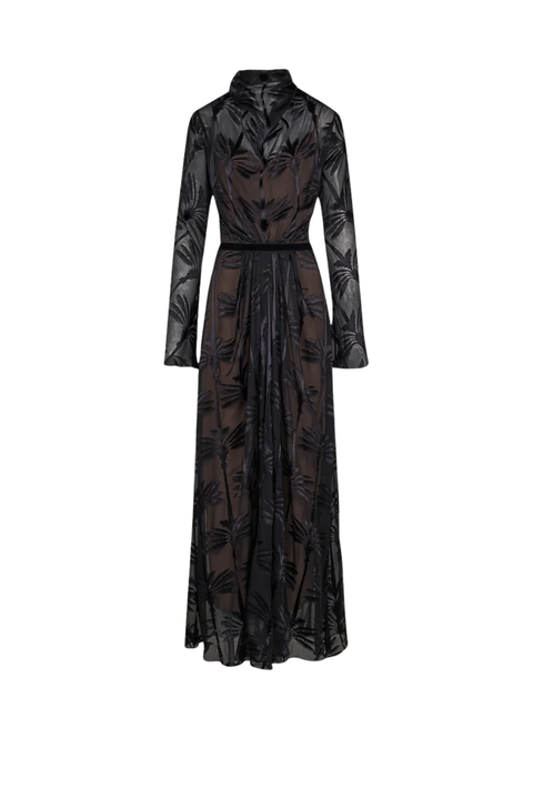 A long-sleeved black sheer mesh maxi dress with a dark brown underlayer and a tonal leaf pattern, featuring a high collar and a self-tie waist belt.