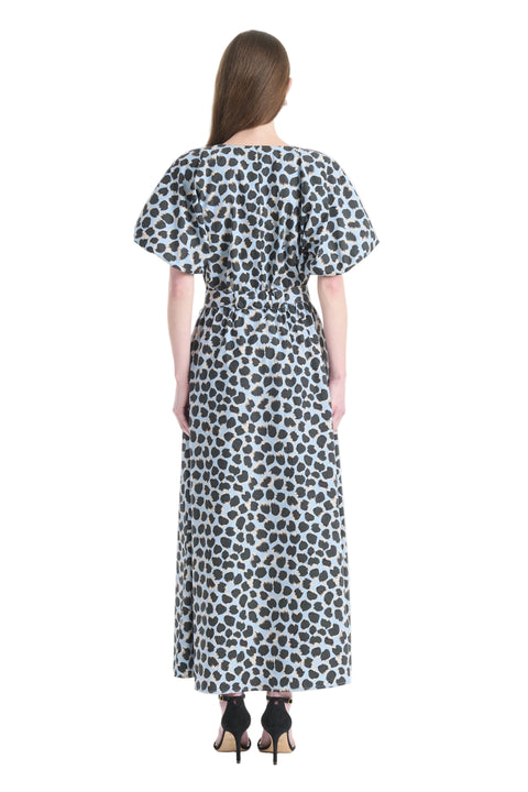 Woman facing the back wearing polka dot dress on a white background