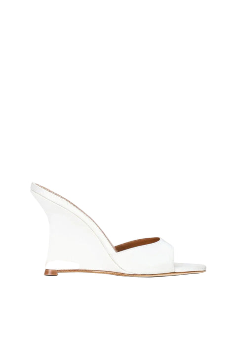 White wedge sandal with a brown insole on a white background