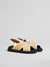 Corner view of the fussbet criss cross sandals in black leather with raffia-effect fabric,