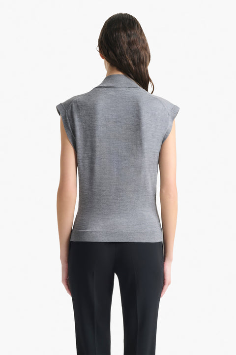 Back of woman wearing grey sweater top.