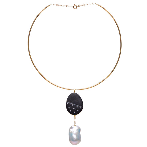 A gold neck wire necklace that features a pendant with a large abstract pearl dangling from a black stone embellished by small round diamonds. 