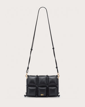 Black quilted handbag with gold accents and a crossbody strap. 