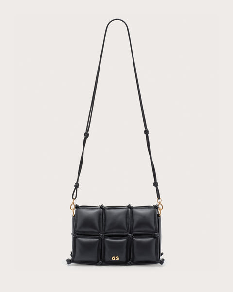 Black quilted handbag with gold accents and a crossbody strap. 