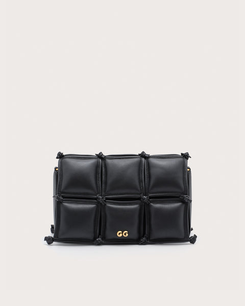 Black quilted handbag with gold accents. 
