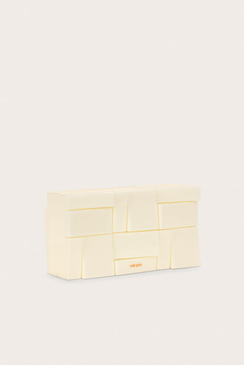 Angled view of the white abstract rectangular acrylic clutch.