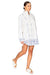 Model walking to the right showing the side of the white printed poplin shirt dress.