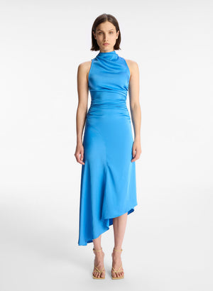 Full body view of a model facing the camera in the blue mock neck midi dress