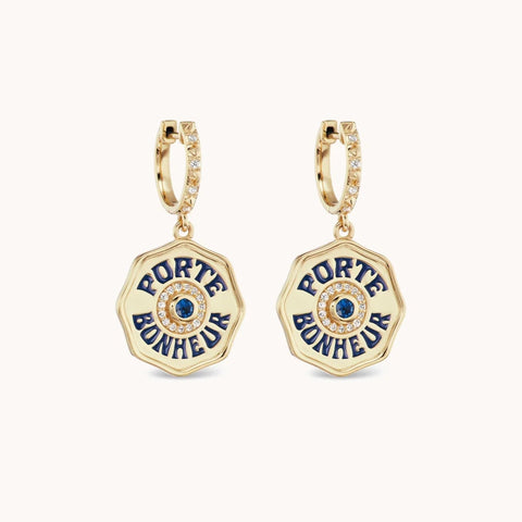 Yellow gold hoop earrings with porte bonheur charms with navy enamel, blue sapphire and diamonds.