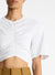 Close up of the ruching and details of the white cropped tee on a model