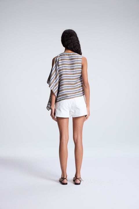 Woman facing the back wearing a striped sleeveless top and white shorts on a plain background