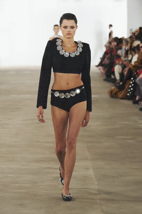 Model walking the runway wearing the black jumbo crystal cropped blazer.
