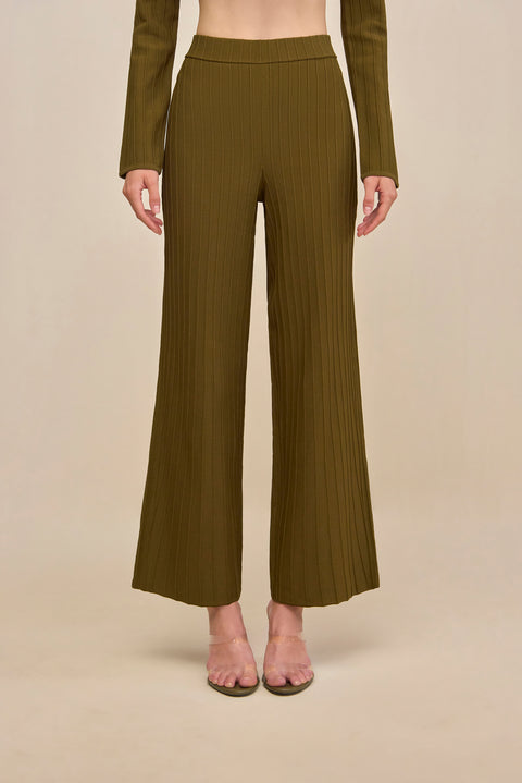 Close up of a woman wearing green ribbed wide leg pants. 