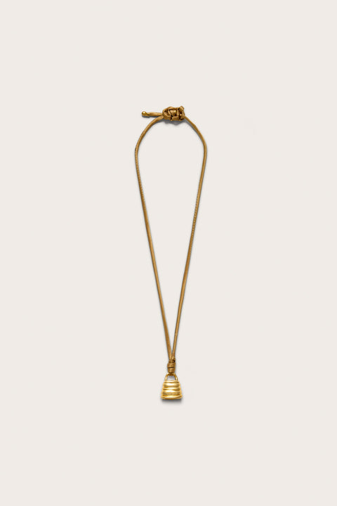 A brown satin adjustable corded necklace with an abstract gold-toned lock pendant. 