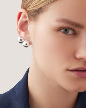 Up close of model ear wearing silver lyra climber earring.