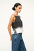 Side view of a woman wearing a boxy black and white dip dye tan top that is open on the sides and fastens with ties. 