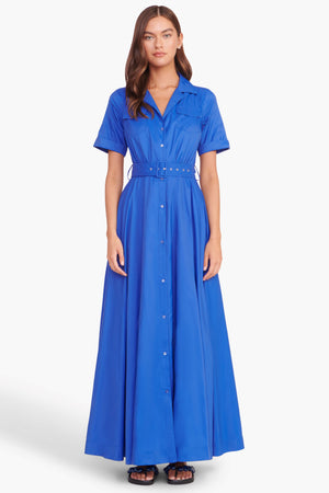 Full body view of a model facing the camera in the bright blue belted maxi dress