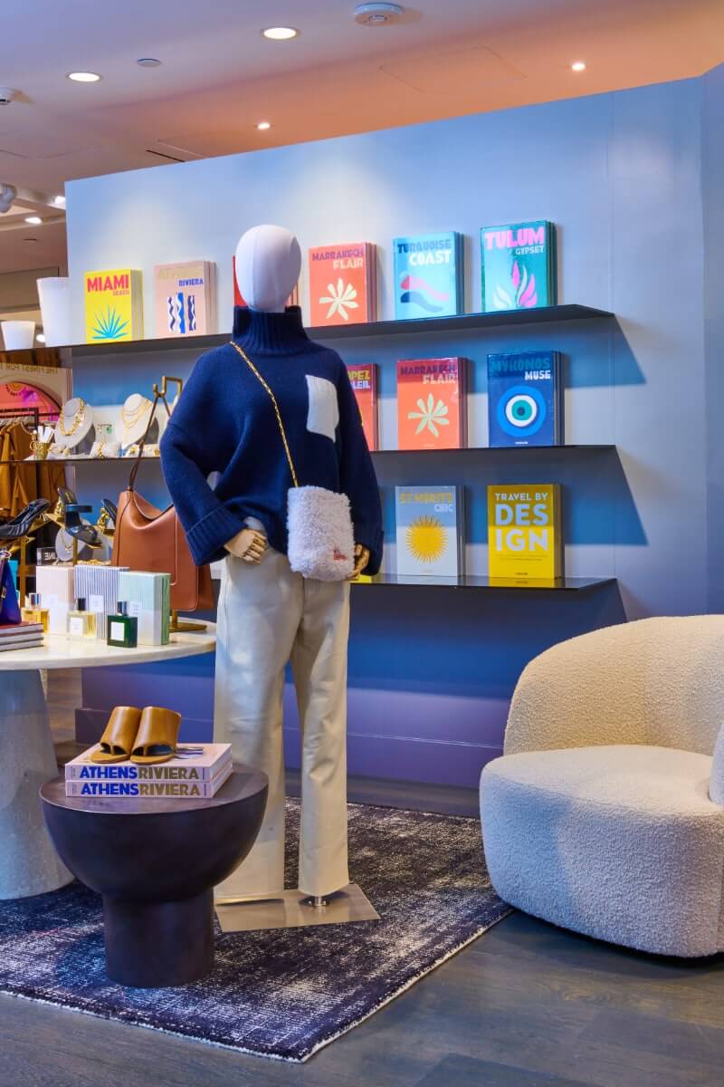 Photo of book display behind lounge chair and mannequin