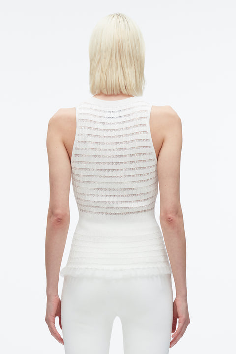 Woman facing away showing back of white variegated striped tank top.