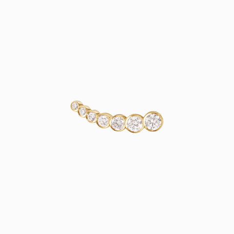 Gold earring with diamonds in a slight curve on a white background