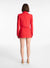 Model facing the back in the red cropped blazer and matching mini skirt