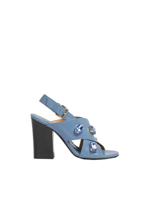 Blue sandal with a block heel on a beige background