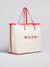 Side view of the janis tote with marni on the front and red leather straps.
