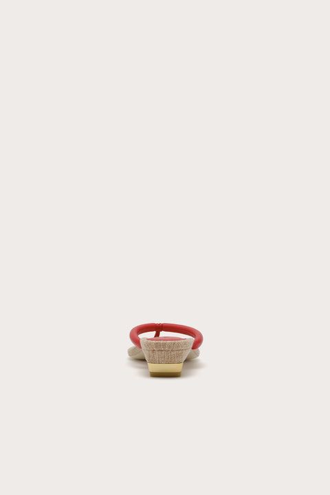 Back-facing shot of sandal with a red thin strap on a white background.