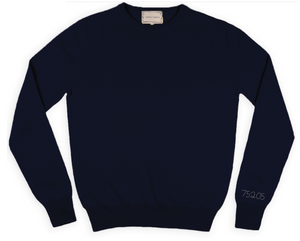 Navy crewneck sweater with 75205 stitched on the right cuff in silver thread.