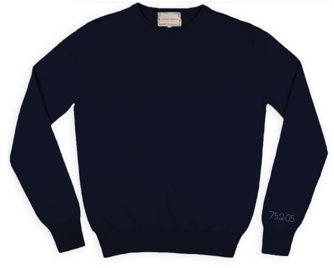 Navy crewneck sweater with 75205 stitched on the right cuff in silver thread.
