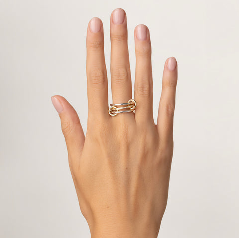 A woman wearing a Spinelli Kilcollin Sonja SG ring. 
