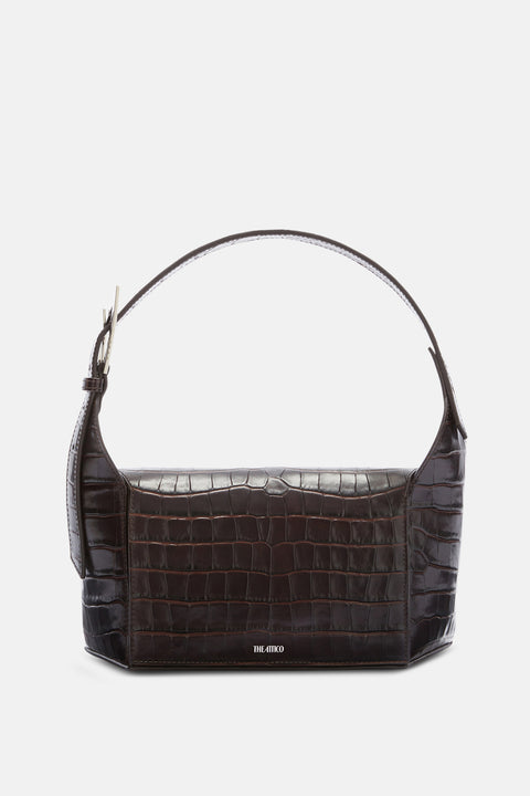 A dark brown, crocodile leather shoulder bag that features an adjustable strap with silver hardware and a magnetic flap closure. 