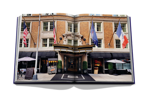 Opened book revealing images of a hotel within coffee table book that is titled "The Mark"