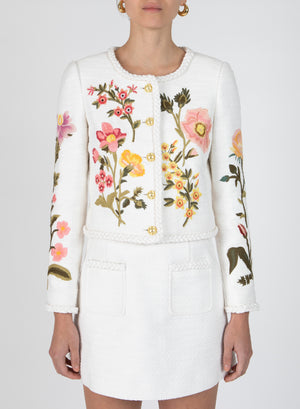 Model wearing the penelope crew neck jacket in white with floral embroidery.
