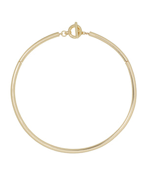 A gold-toned, tubular collar necklace with a toggle clasp.