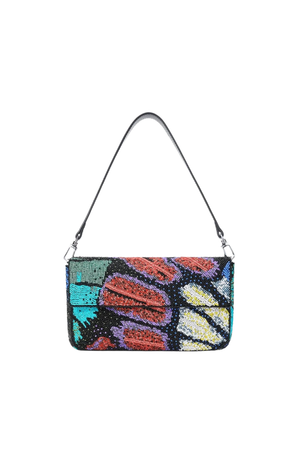 A small shoulder bag with a black leather strap and a colorful butterfly-wing pattern made of sequins in red, orange, yellow, teal, purple, and black, shown on a plain white background.