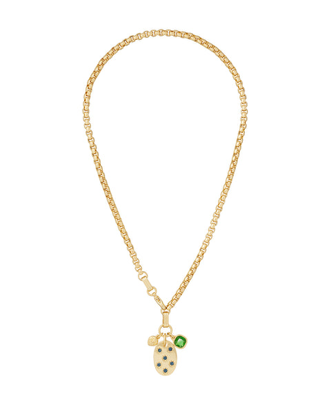 A gold-tone chain necklace that features a star-set sapphire pendant with an emerald charm. 