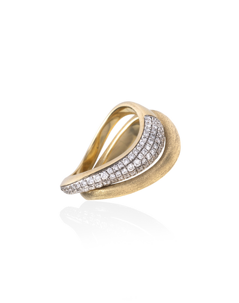 Two stackable brushed yellow gold rings with top ring including pave diamonds.