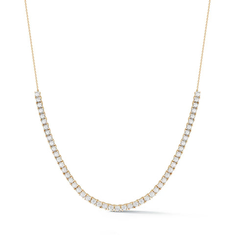 A yellow gold tennis necklace with white diamonds. 