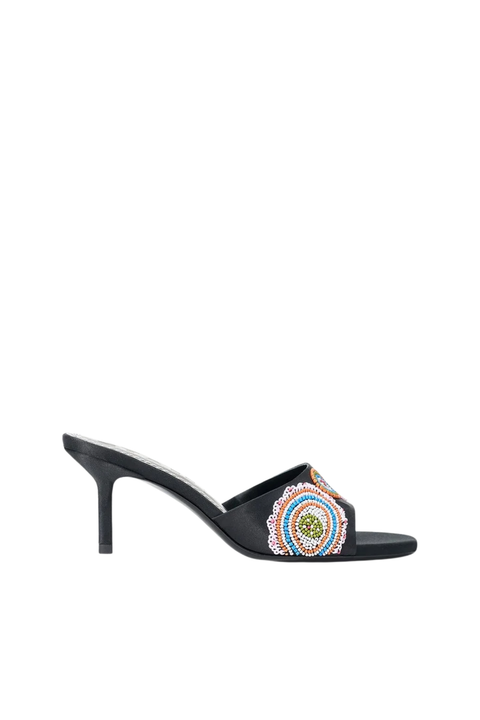 Black slingback shoe with decorative element on a white background
