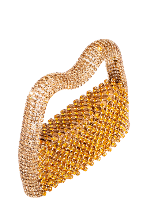 A gold embellished mesh clutch purse with a wavy, flap-top design, photographed on a solid white background.