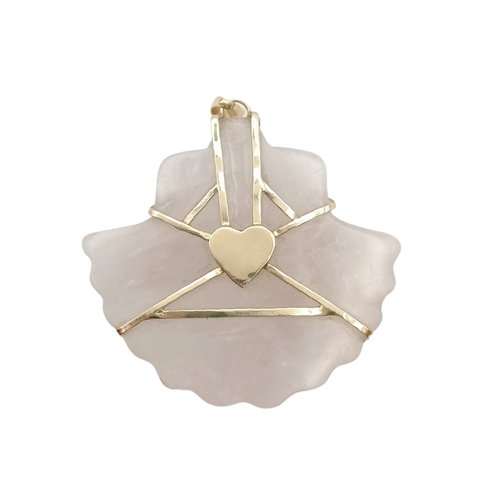 Decorative item with gold accents on shell pendant and a heart design on a white background