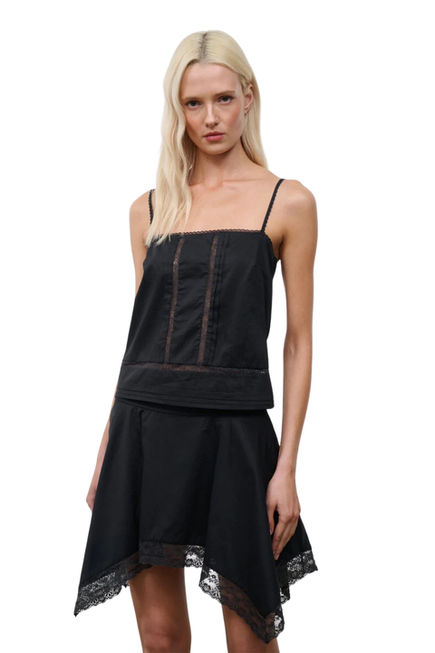 Close-up of A woman wearing a black sleeveless top with a matching skirt