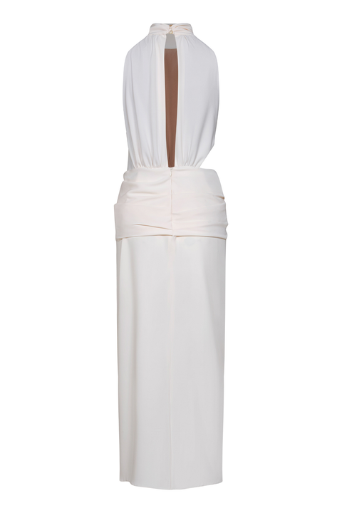 An ankle-length cream halter dress with waist draping and a back slit