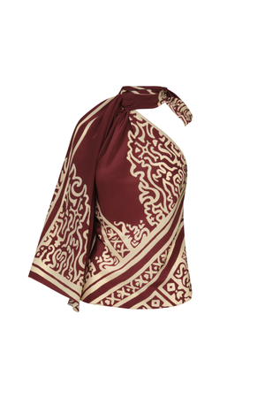 A burgundy and ecru patterned top with one draped sleeve and a halter tie-neck