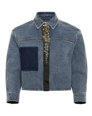 Blue denim jacket with metallic decorative elements on a white background