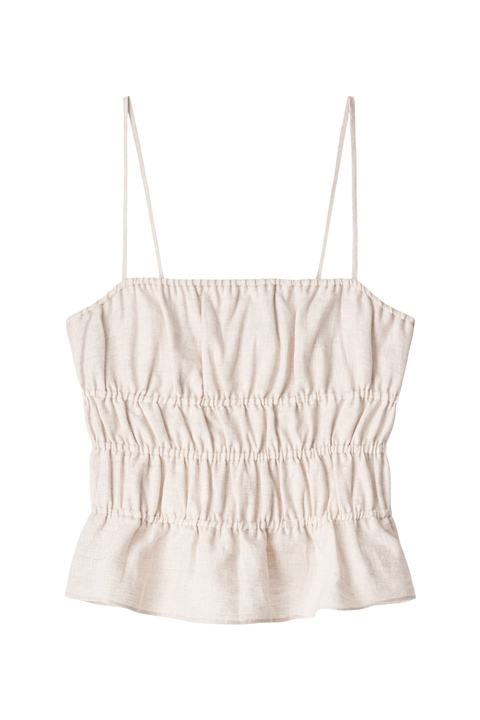 A light beige linen camisole top with thin spaghetti straps and a smocked bodice, shown flat on a white background.