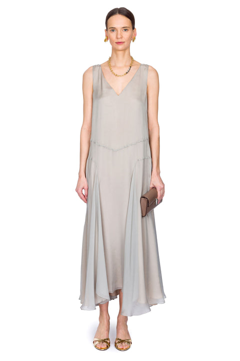 Woman wearing a light gray dress on a white background